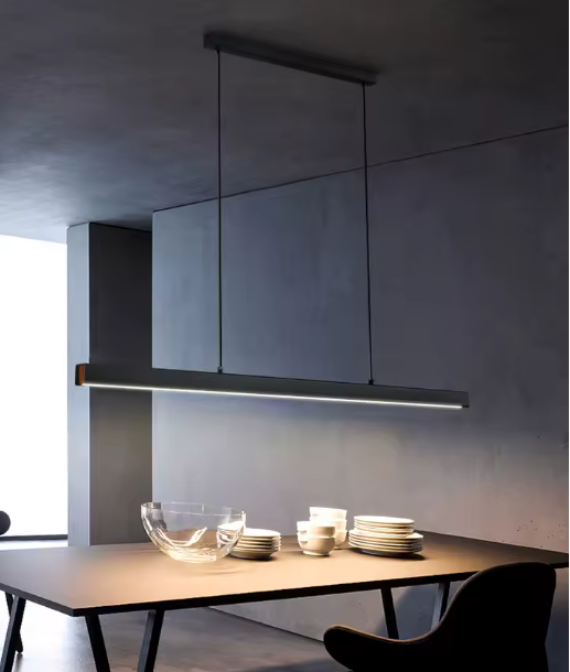 Libreville modern linear LED pendant light in matte black above a dining table