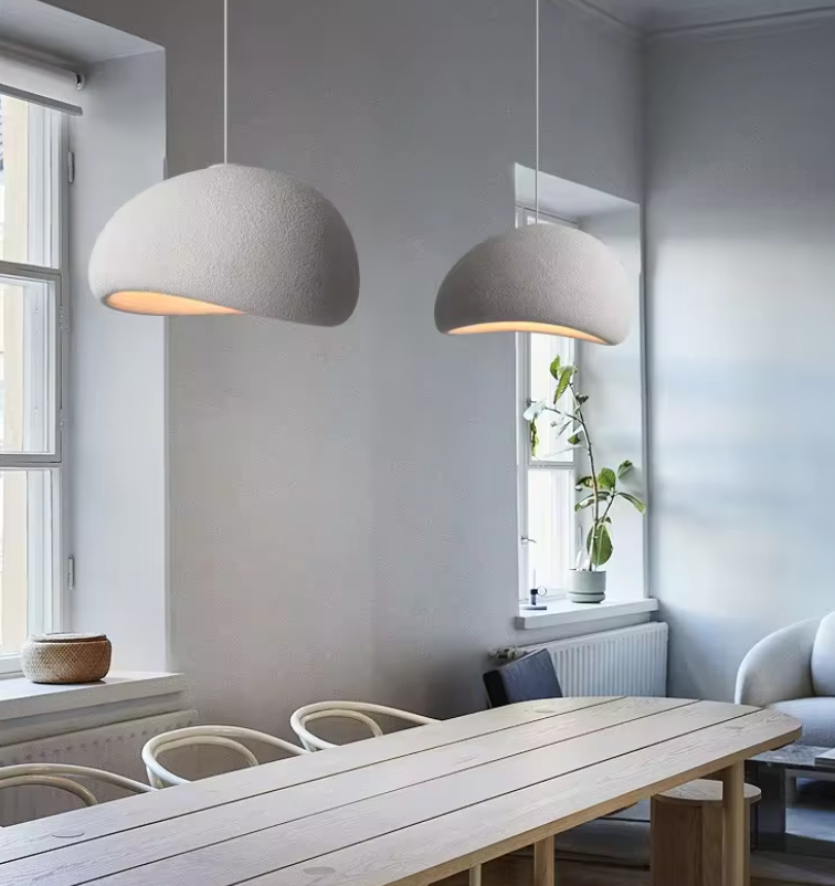 Papeete pendant light with textured dome shade hanging above a modern dining table in a minimalist interior