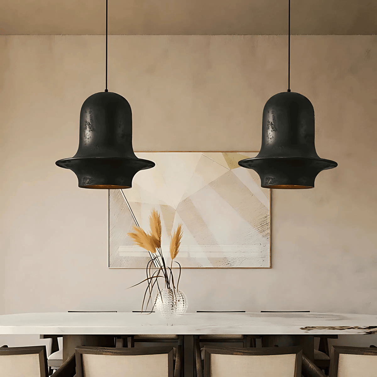 Two black Tunis pendant lights with bell-shaped resin shades hanging above a modern dining table