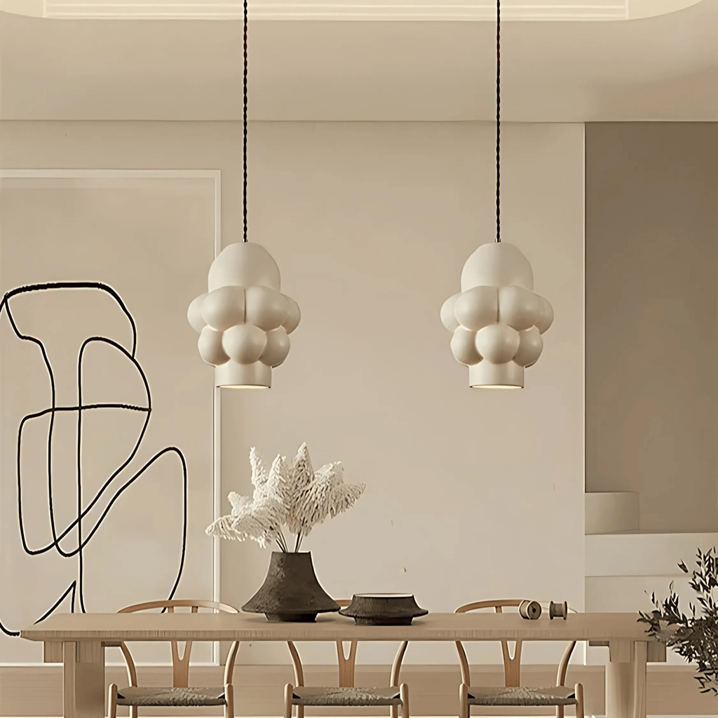 Riga pendant light in a modern dining room with white resin bubble shades and warm ambient lighting