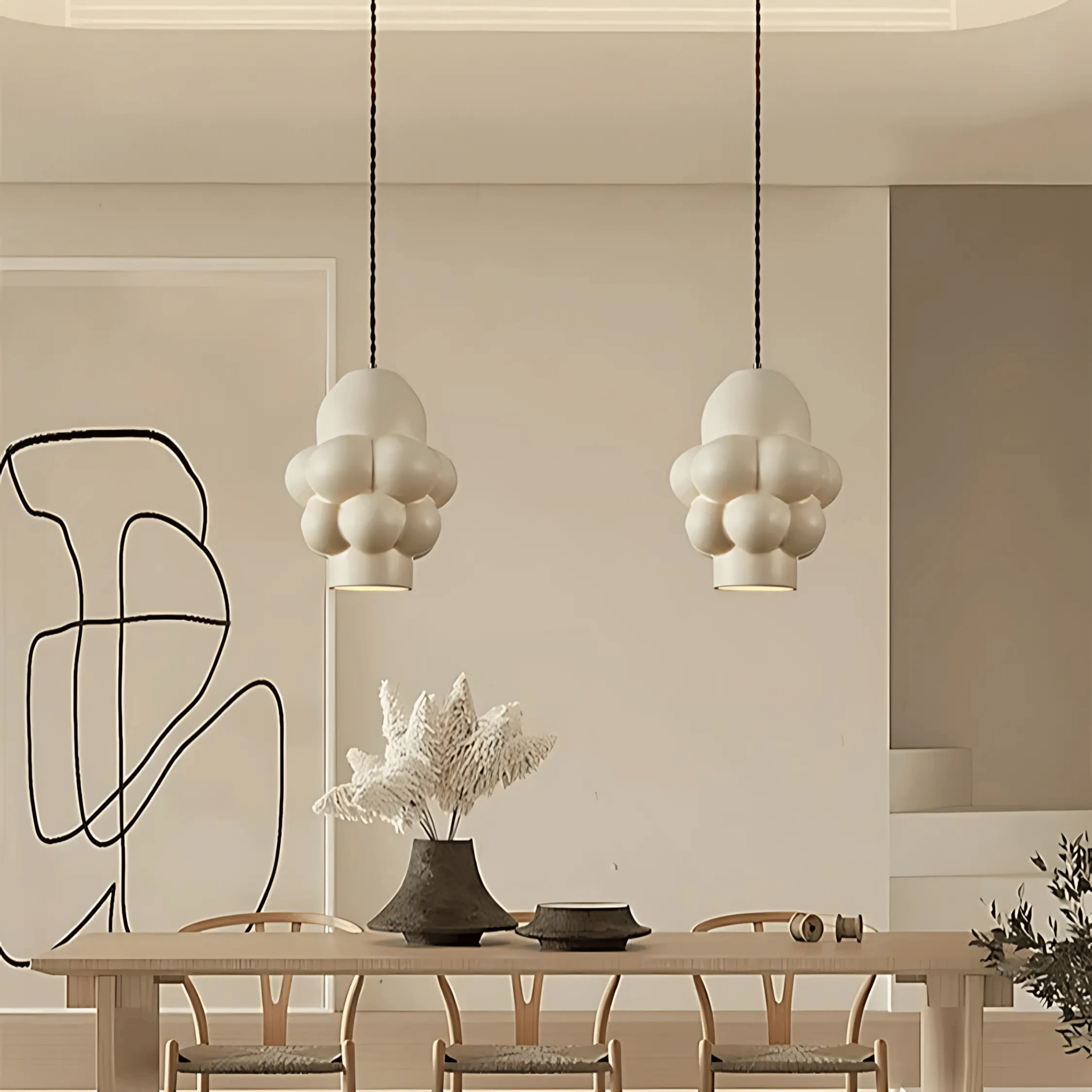 Riga pendant light in a modern dining room with white resin bubble shades and warm ambient lighting