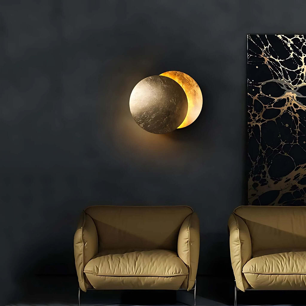 Doha modern LED wall light with layered circular metal design glowing on a dark living room wall