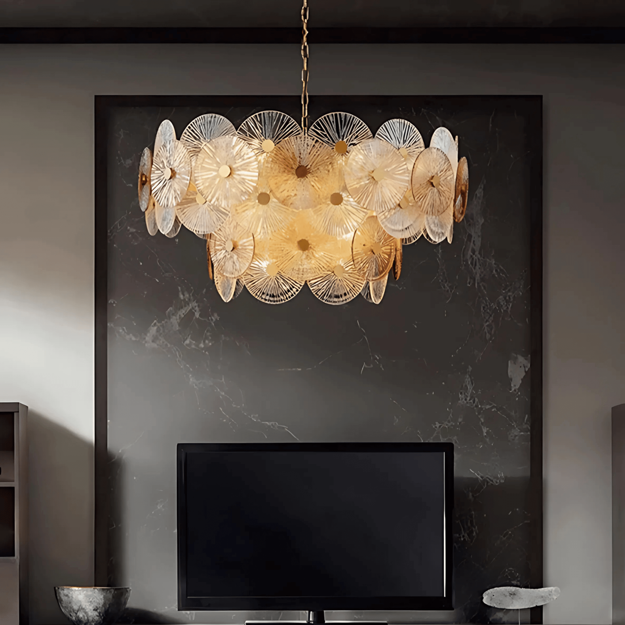 Paris chandelier with layered ribbed glass discs and warm light above a modern fireplace wall