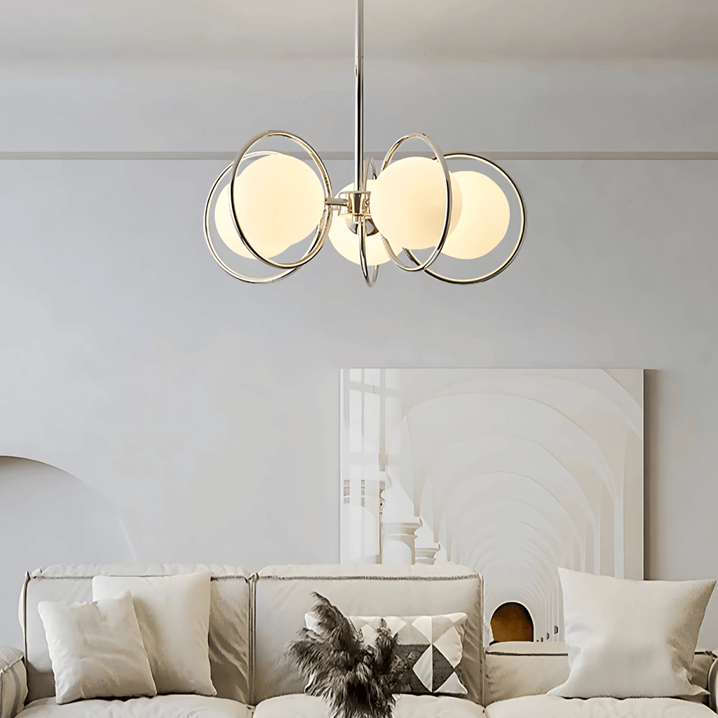 Kabul chandelier modern glass pendant light with glowing globe shades and metal rings above a contemporary sofa
