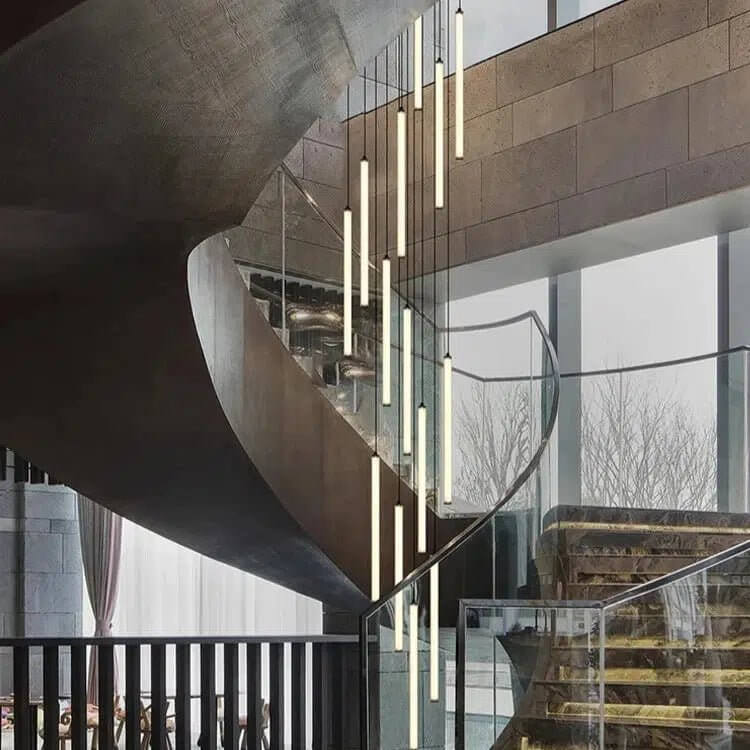 Bissau modern LED chandelier with hanging tube lights above a curved staircase and glass railing