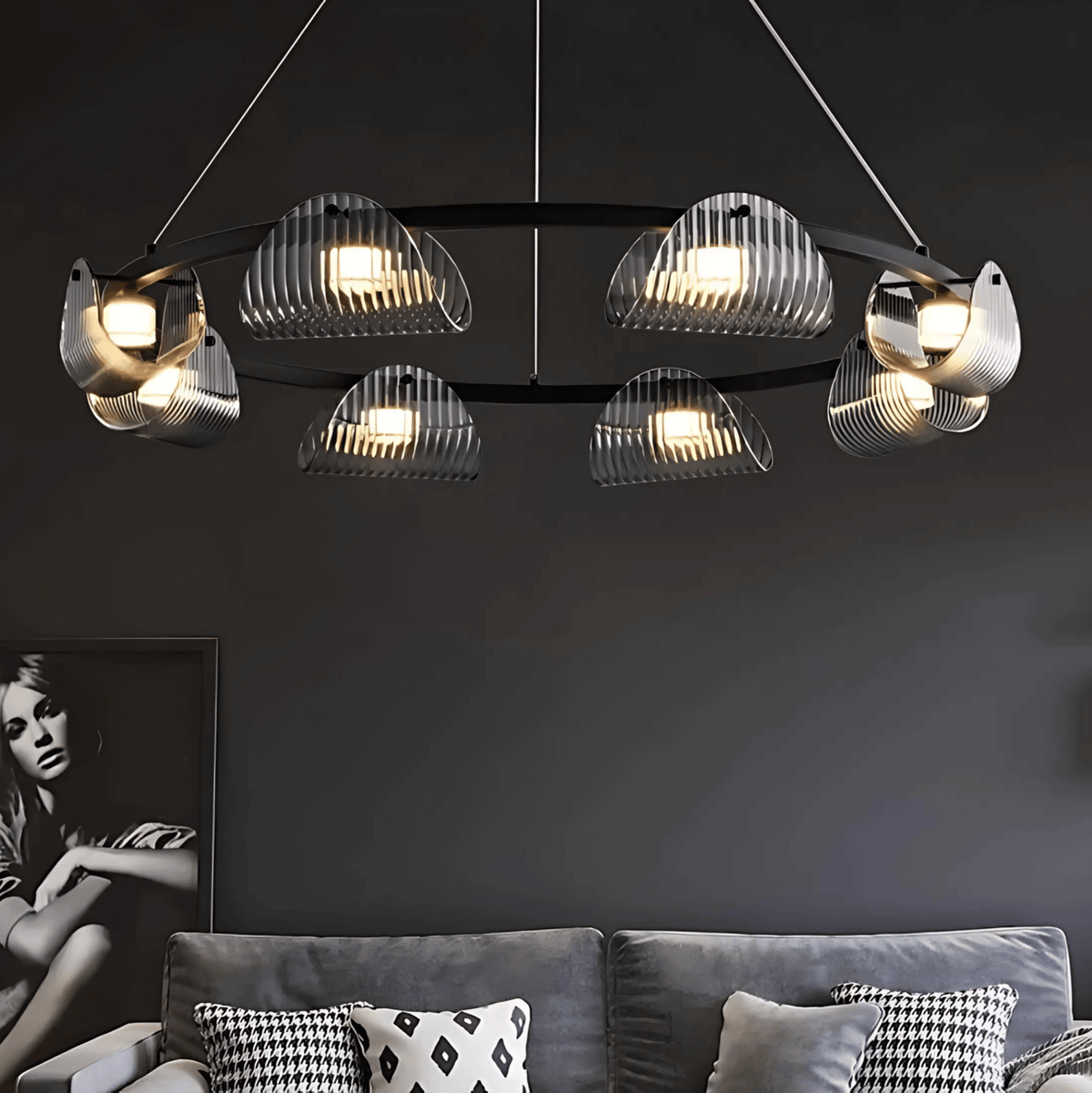 Modern Gibraltar chandelier with textured glass shades and LED lights above a contemporary living room sofa